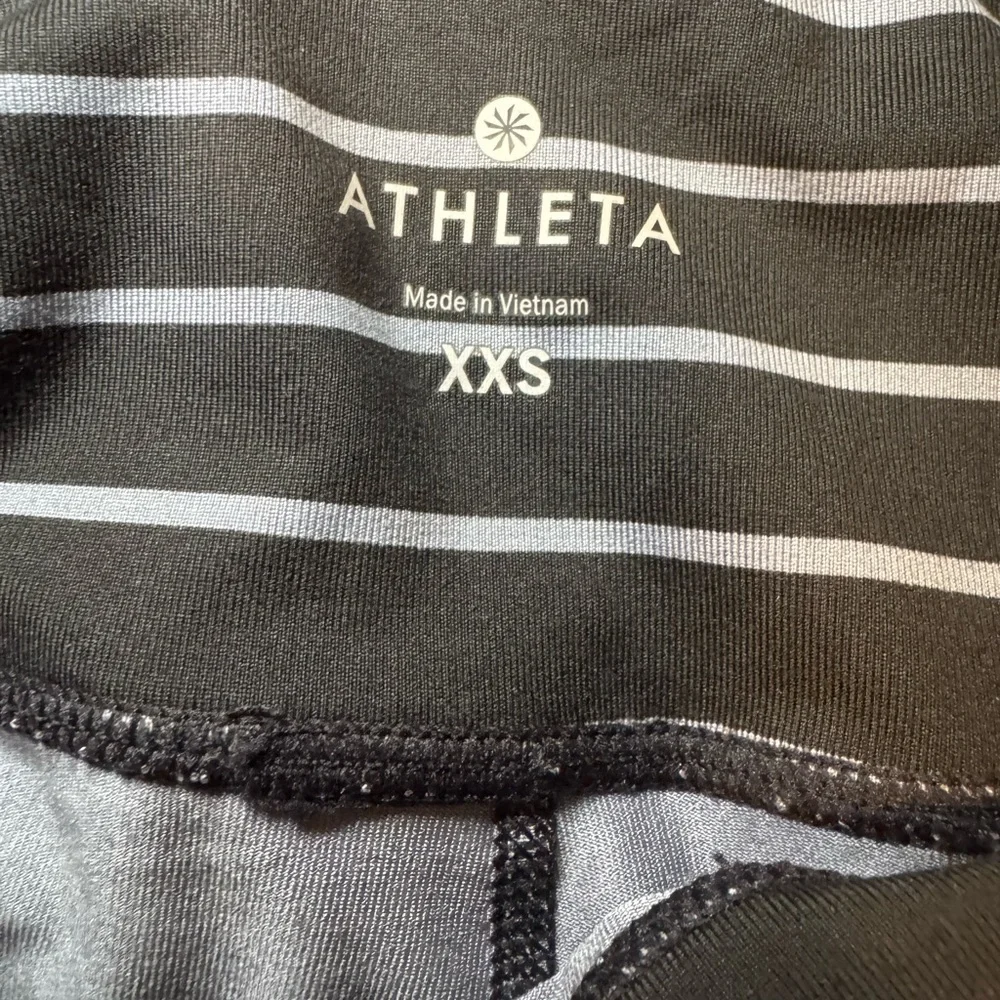 Athleta Chaturanga tight leggings in a black and gray striped pattern